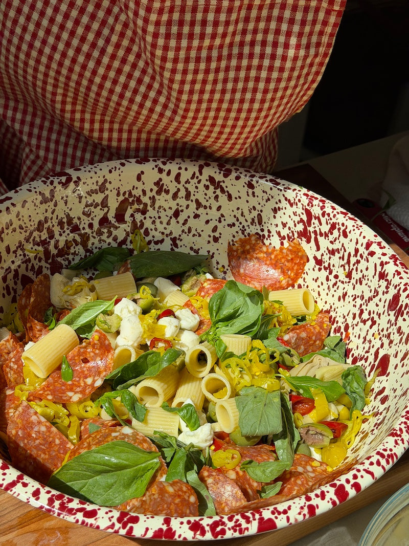 A pasta salad with fresh basil, mozzarella, salami, and Ayoh Hot Giardinayo